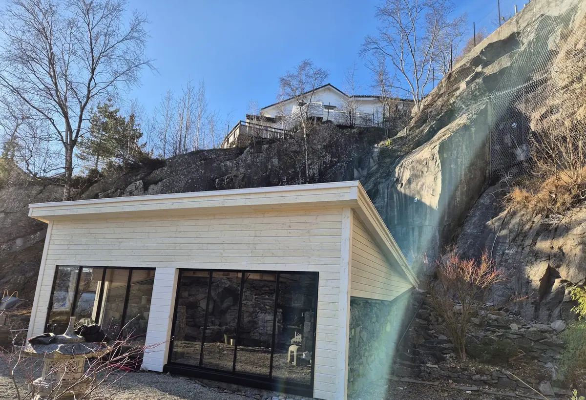 Tilbygg med glassfasade foran fossen