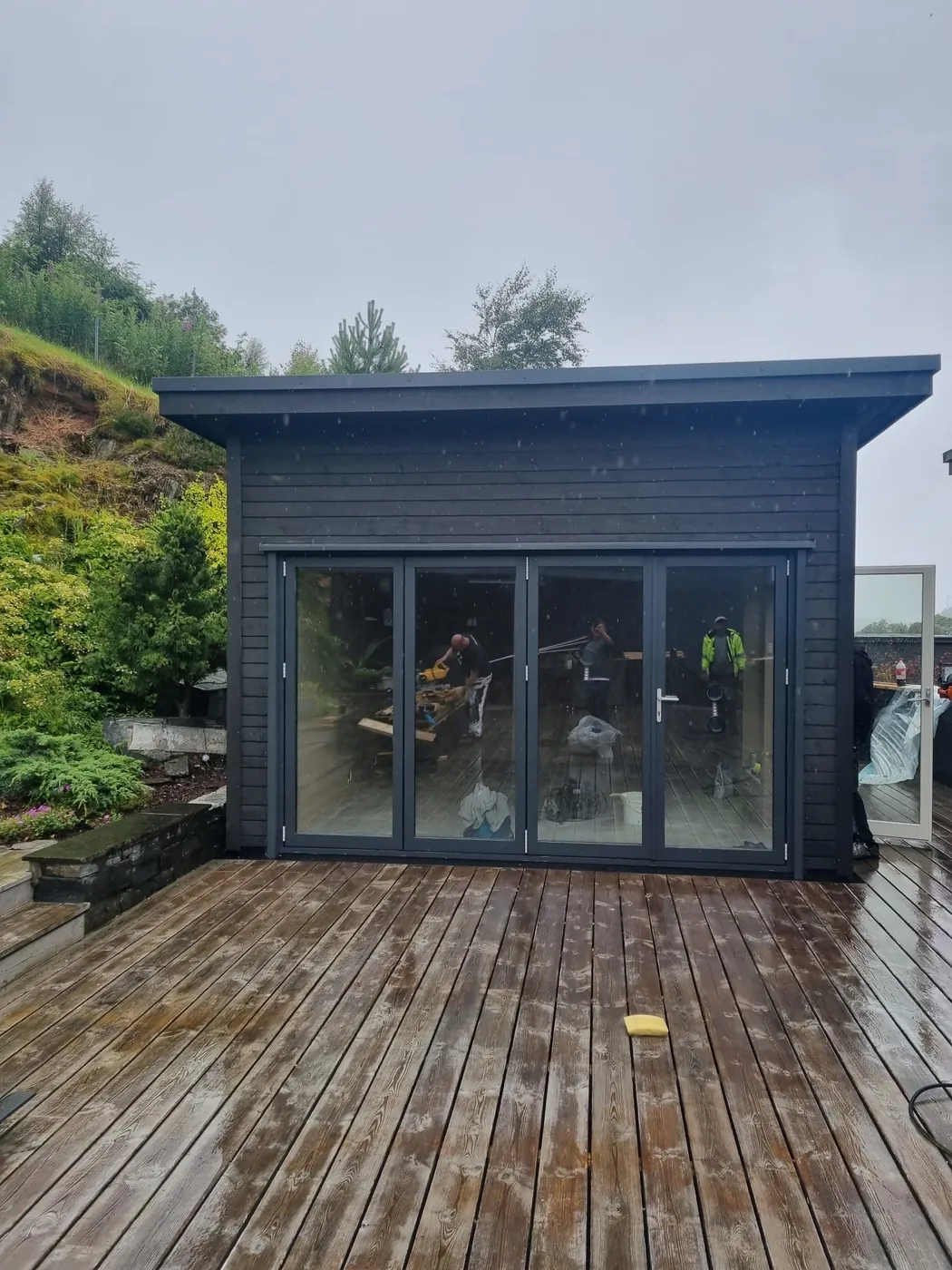 Ferdig uterom i sort panel med glassfront